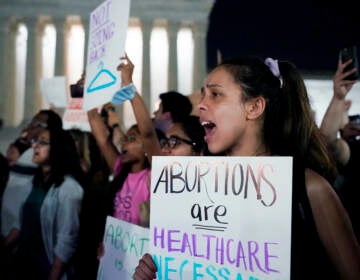 A crowd of people gather outside the Supreme Court protesting a draft opinion regarding Roe v. Wade