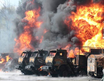 Vehicles on fire at the oil depot after missiles struck the facility in an area controlled by Russian-backed separatist forces