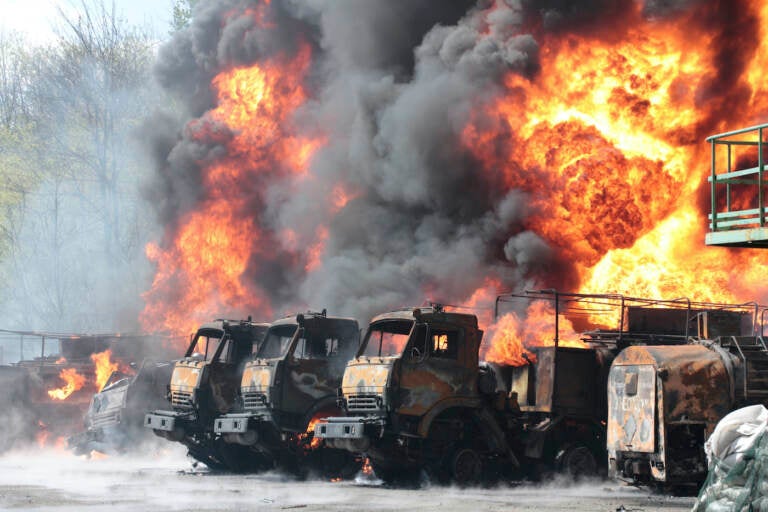 Vehicles on fire at the oil depot after missiles struck the facility in an area controlled by Russian-backed separatist forces