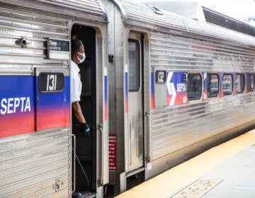 A person looks out of a SEPTA Regional Rail train