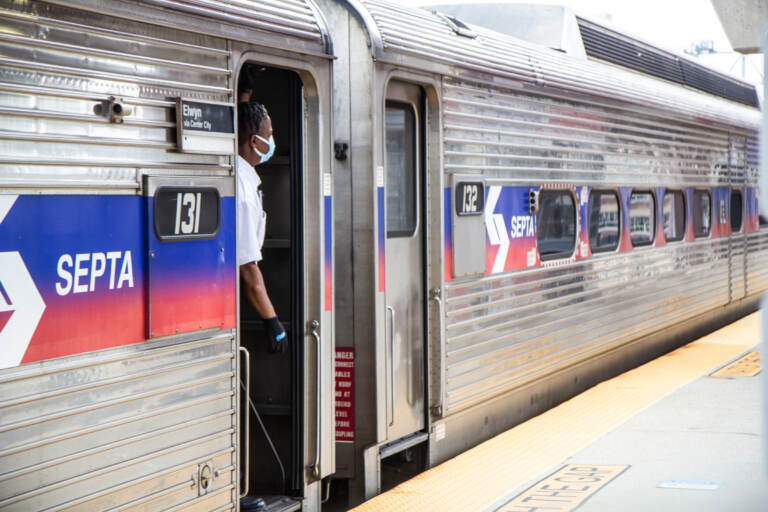 A person looks out of a SEPTA Regional Rail train