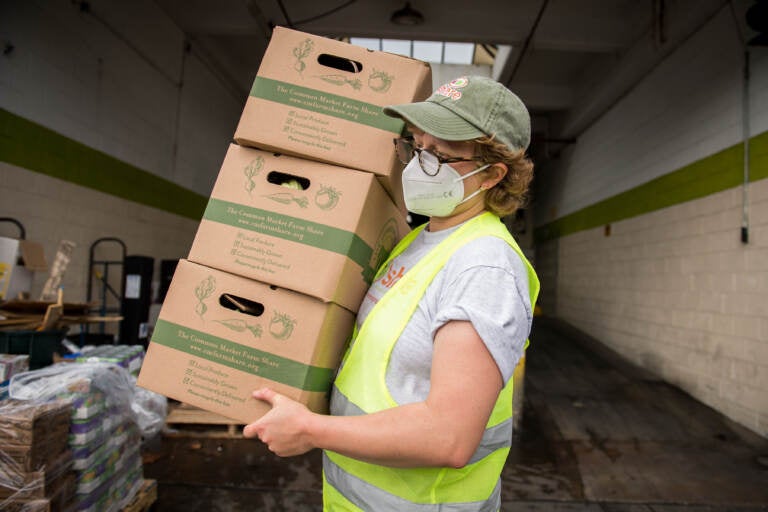 A Share Food Program worker is seen carrying boxes