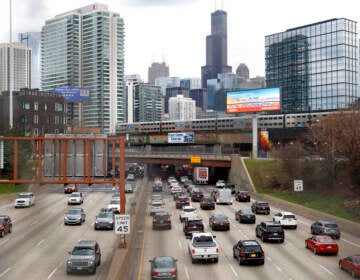 File photo: Traffic flows along Interstate 90 highway as a Metra suburban commuter train moves along an elevated track in Chicago on March 31, 2021. With upcoming data showing traffic deaths soaring, the Biden administration is steering $5 billion in federal aid to cities and localities to address the growing crisis by slowing down cars, carving out bike paths and wider sidewalks, and nudging commuters to public transit.