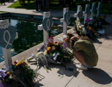 Elena Mendoza grieves in front of a cross honoring her cousin, Amerie Jo Garza