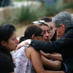 The Archbishop of San Antonio, Gustavo Garcia Seller comforts families outside of the Civic Center in Uvalde