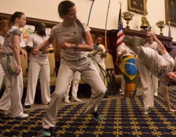 Members of the Brazilian performance group Project Capoeira are seen in motion