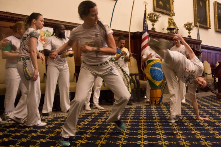 Members of the Brazilian performance group Project Capoeira are seen in motion