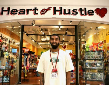 Chris Newsome stands in front of Heart of Hustle at the Cumberland Mall