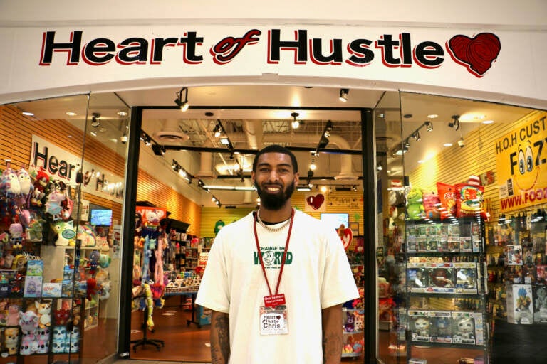 Chris Newsome stands in front of Heart of Hustle at the Cumberland Mall