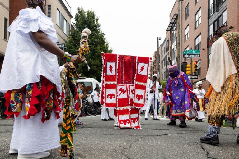 Performers dance on South Street during the Odunde procession.