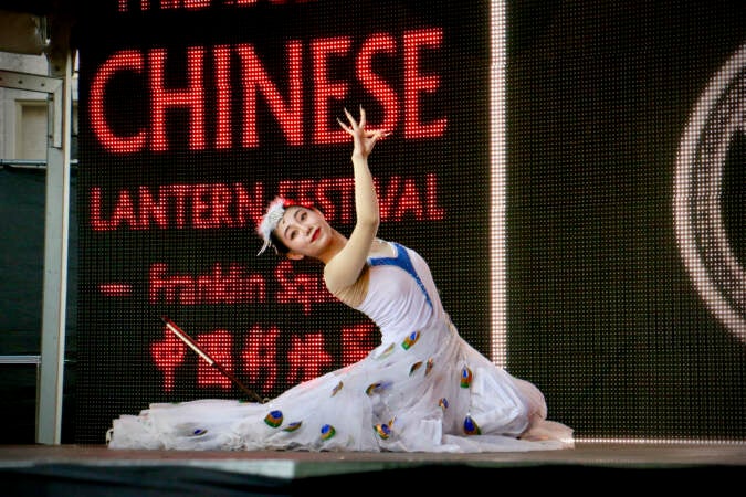 A folk dancer performs on stage at the Chinese Lantern Festival in Philadelphia's Franklin Square. (Emma Lee/WHYY)