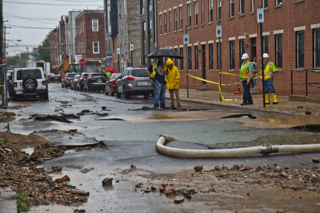 Crews are pictured at the scene of a water main break near Fourth and Hewson streets
