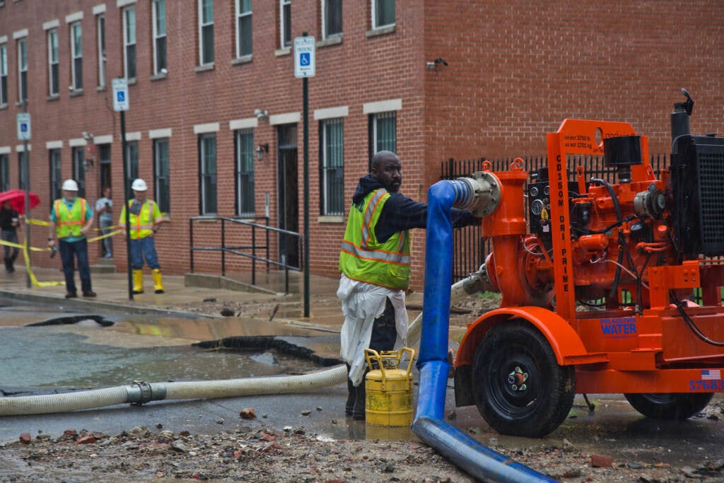 Crews are pictured at the scene of a water main break near Fourth and Hewson streets