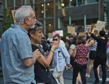 Emotional onlookers thank protesters marching down Market Street in support of abortion rights on June 24, 2022. (Kimberly Paynter/WHYY)