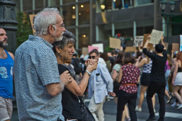 Emotional onlookers thank protesters marching down Market Street in support of abortion rights on June 24, 2022. (Kimberly Paynter/WHYY)