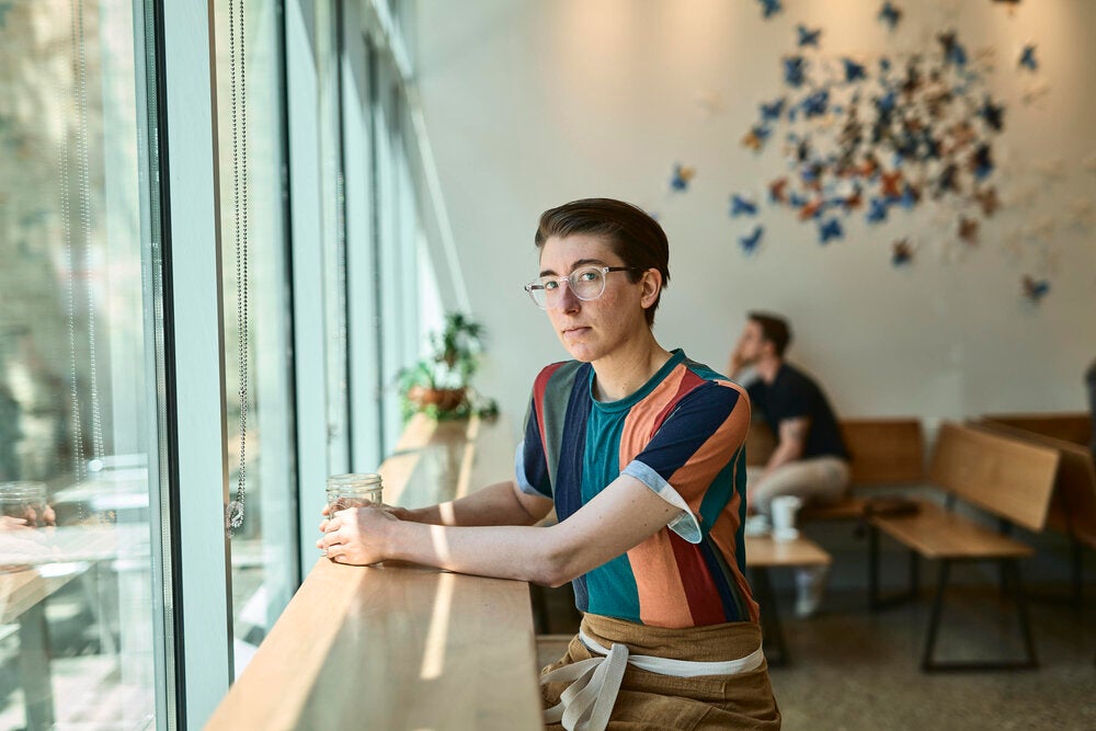 Steph Achter stands inside a coffee shop