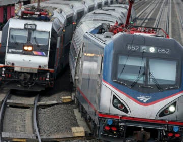 In this March 12, 2016, file photo, an Amtrak train passes a New Jersey Transit train stopped to discharge and board passengers at Elizabeth train station in Elizabeth, N.J., along Amtrak's Northeast Corridor. (AP Photo/Mel Evans, File)