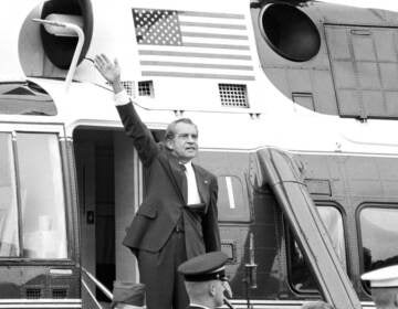 In this Aug. 9, 1974 file photo, President Richard Nixon waves goodbye from the steps of his helicopter outside the White House, after he gave a farewell address to members of the White House staff after resigning. (AP Photo/Chick Harrity)