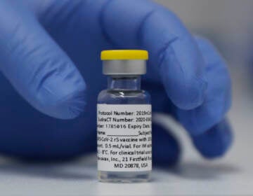 In this Wednesday, Oct. 7, 2020, file photo, a vial of the Phase 3 Novavax coronavirus vaccine is seen ready for use in the trial at St. George's University hospital in London. (AP Photo/Alastair Grant, File)