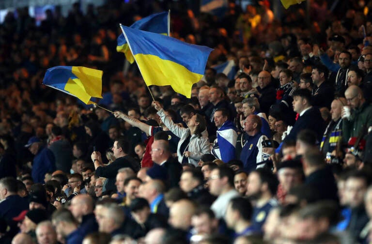 Football supporters show their support to Ukraine during the International Friendly soccer match between Scotland and Poland at Hampden Park stadium in Glasgow, Scotland, Thursday, March. 24, 2022. (AP Photo/Scott Heppell)