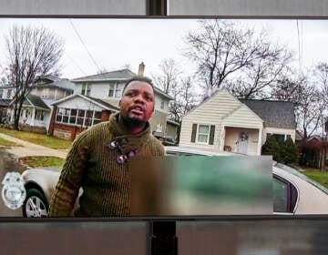 A TV display shows video evidence of a Grand Rapids police officer struggling with and shooting Patrick Lyoya at Grand Rapids City Hall on Wednesday, April 13, 2022. (Cory Morse | MLive.com)