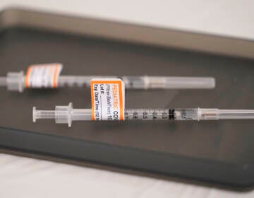 File photo: Prepared Pfizer COVID-19 vaccine syringes for children ages 5 to 11 and adults are displayed on a table at Northwest Community Church in Chicago, Dec. 11, 2021. (AP Photo/Nam Y. Huh, File)