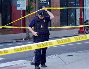 Philadelphia police investigators work the scene of a fatal overnight shooting on South Street in Philadelphia, Sunday, June 5, 2022. (AP Photo/Michael Perez)