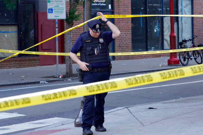 Philadelphia police investigators work the scene of a fatal overnight shooting on South Street in Philadelphia, Sunday, June 5, 2022. (AP Photo/Michael Perez)