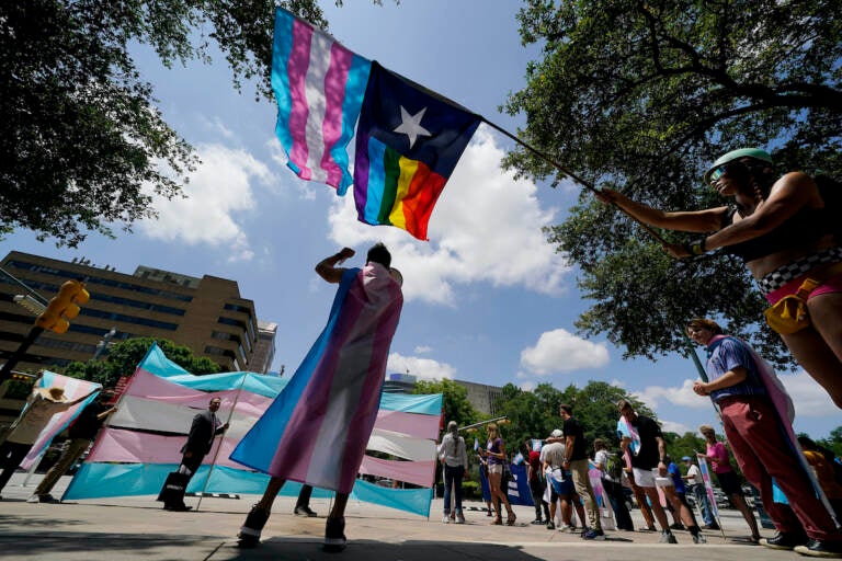 File photo: Demonstrators gather on the steps to the State Capitol to speak against transgender-related legislation bills being considered in the Texas Senate and Texas House, May 20, 2021, in Austin, Texas. A Texas judge on Friday, June 10, 2022, temporarily blocked the state from investigating families of transgender children who have received gender-confirming medical care, a new obstacle to the state labeling such treatments as child abuse. (AP Photo/Eric Gay, File)