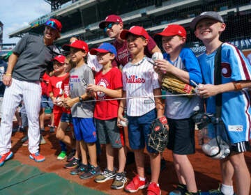 Philadelphia Phillies' Bryson Stott, left, poses with West Chester'sCaden Marge, sixth from right, and a bunch of fans during warmups prior to a baseball game against the Arizona Diamondbacks, Friday, June 10, 2022, in Philadelphia. (AP Photo/Chris Szagola)