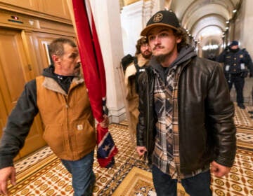 Kevin Seefried (left) and his son Hunter march through the U.S. Capitol during the Jan. 6, 2021 insurrection.