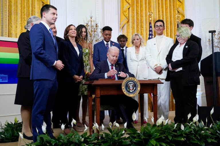 President Joe Biden signs an executive order at an event to celebrate Pride Month in the East Room of the White House, Wednesday, June 15, 2022, in Washington. (AP Photo/Patrick Semansky)