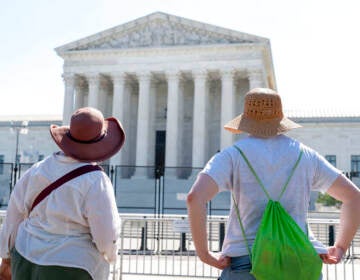 Women in sunhats look at the Supreme Court, Thursday, June 30, 2022, in Washington. (AP Photo/Jacquelyn Martin)