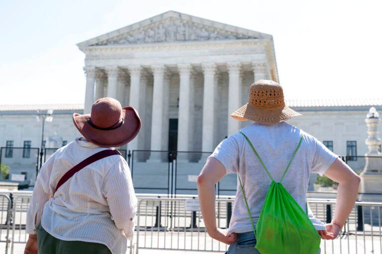 Women in sunhats look at the Supreme Court, Thursday, June 30, 2022, in Washington. (AP Photo/Jacquelyn Martin)