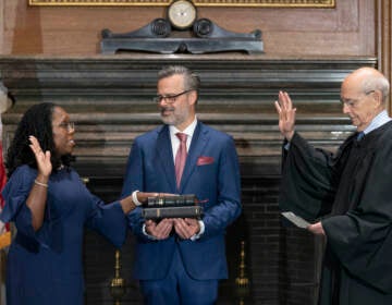 In this image provided by Collection of the Supreme Court of the United States, retired Supreme Court Justice Stephen Breyer administers the Judicial Oath to Ketanji Brown Jackson as her husband Patrick Jackson holds the Bible at the Supreme Court in Washington, Thursday, June 30, 2022. (Fred Schilling/Collection of the Supreme Court of the United States via AP)