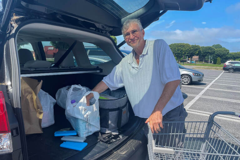 Bob Hayman has accumulated lots of thick reusable plastic bags that stores provided after they exploited a legal loophole. (Cris Barrish/WHYY)