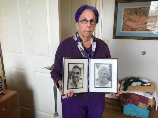 Many of the fired teachers remained dedicated to left-wing political causes. Abraham Egnal (left) organized against nuclear testing and proliferation. Here, his daughter, Freda, holds his portrait. (Avi Wolfman-Arent/WHYY)