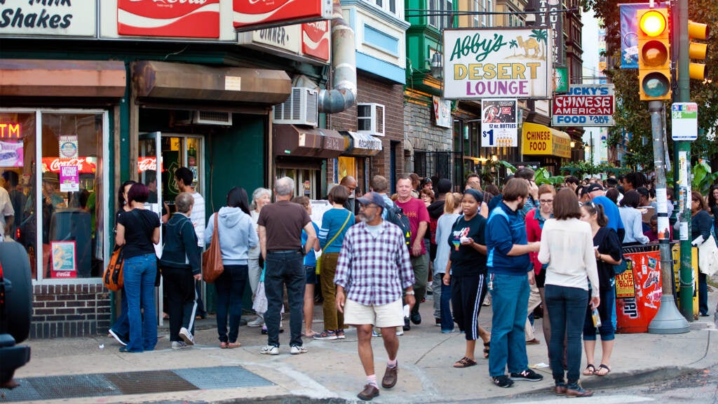 People are seen on Baltimore Avenue during the Dollar Stroll