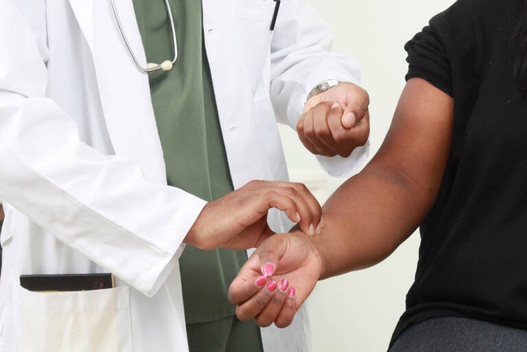 Doctor checks patient's pulse