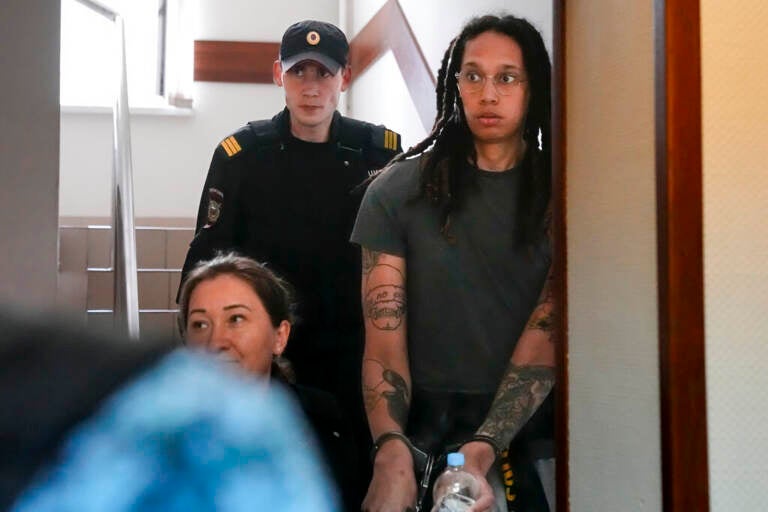 Brittany Griner looks surprised as she led into a courtroom in handcuffs.