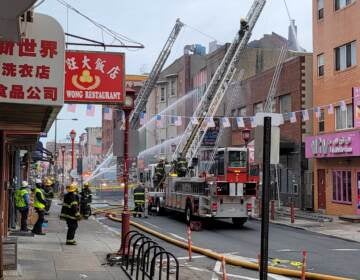 The fire has caused an almost complete shutdown of the Chinatown business area. (Tom MacDonald / WHYY)