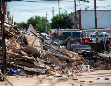 Firefighters at the scene of a building collapse at N 3rd St and W Indiana Ave. in the city's Fairhill section where a 27 year veteran firefighter died. (Jonathan Wilson for Billy Penn)