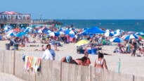 Beachgoers are seen on the beach at the Jersey Shore, with the ocean in the background.