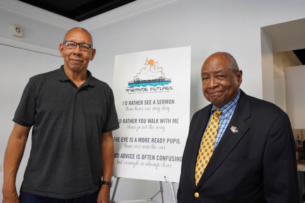 Former Chester Mayor John Linder and Garland Thompson stand next to a sign that reads Riverside Futures.