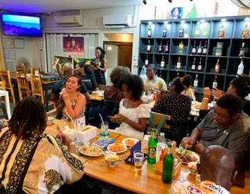 A view from above shows a group of people at a restaurant.