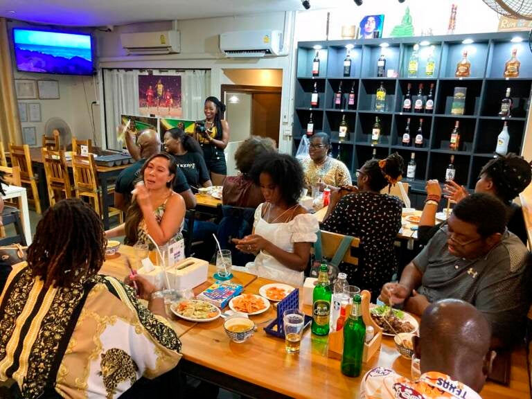 A view from above shows a group of people at a restaurant.