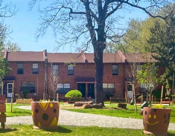 A memorial garden is shown, with houses in the background.