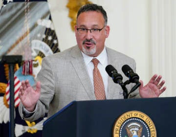 FILE - Education Secretary Miguel Cardona speaks in the East Room of the White House in Washington, April 27, 2022. The Biden administration proposed a dramatic rewrite of campus sexual assault rules on Thursday, June 23, moving to expand protections for LGBTQ students, bolster the rights of victims and widen colleges' responsibilities in addressing sexual misconduct. The proposal was announced on the 50th anniversary of the Title IX women’s rights law. Cardona said Title IX has been “instrumental” in fighting sexual assault and violence in education. (AP Photo/Susan Walsh, File)