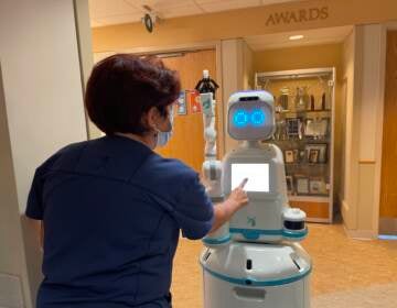 Nurse Tina Merritt engages with Moxi in her cardiac unit at Christiana Hospital.