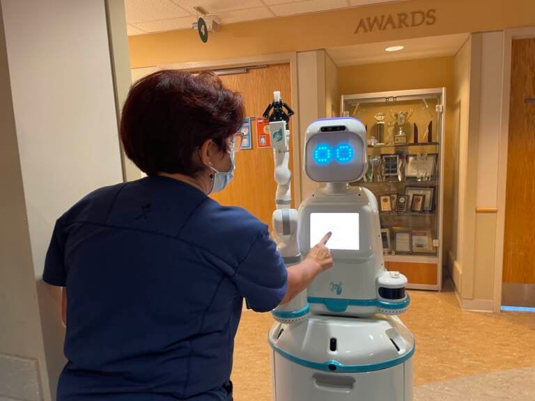 Nurse Tina Merritt engages with Moxi in her cardiac unit at Christiana Hospital.